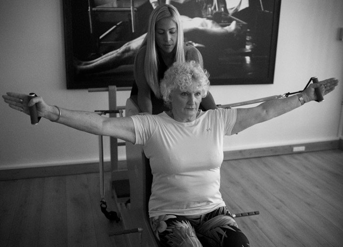Karol instructing a private pilates class with a client
